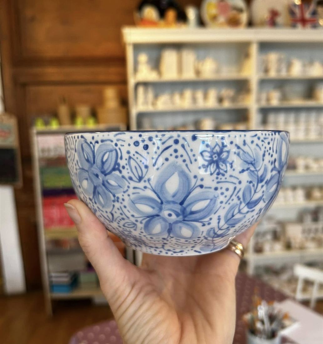 A blue flower bowl painted at Pots of Art