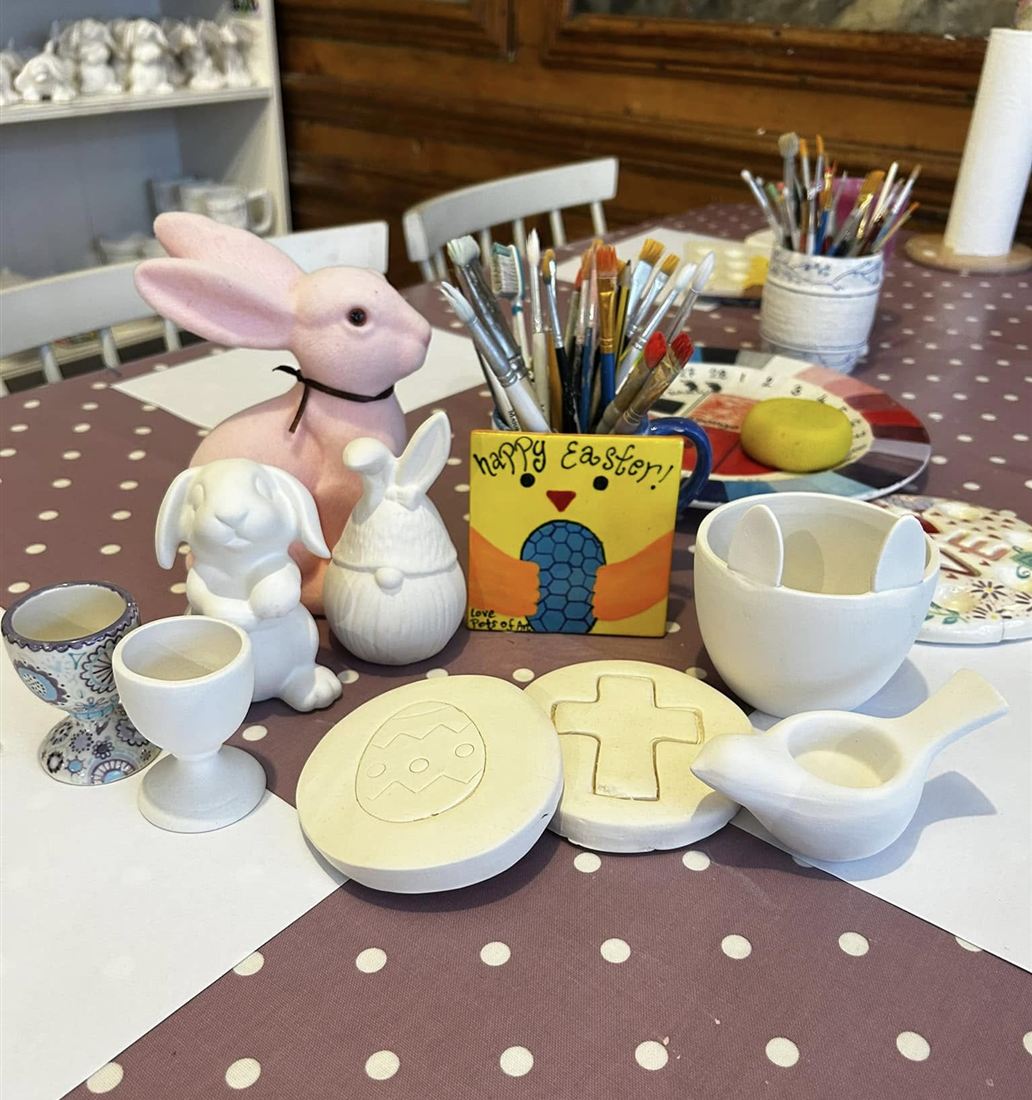 A party table set up with bunnies, brushes and paint